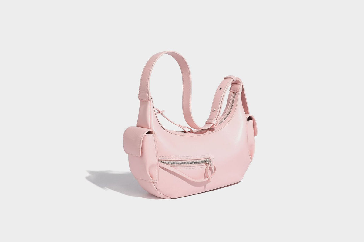 Smooth leather-look crescent shoulder bag with front zip pocket, side flap pockets, adjustable strap, and silver-tone, detail