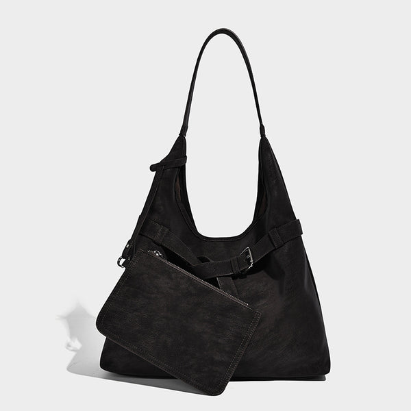 Slouchy oversized shoulder tote bag with matte textured finish, wrap-around buckle strap, and detachable front zip pouch