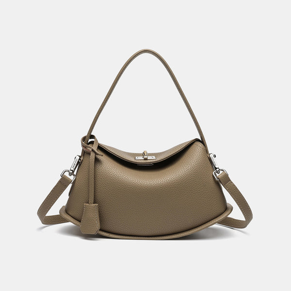 Pebbled leather-look half-moon saddle bag with turn-lock flap closure, top handle, and detachable crossbody strap, detail
