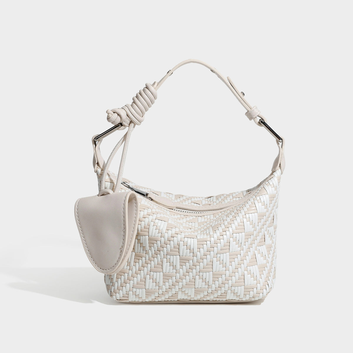 Kleine gewebte Schultertasche mit geometrischem Schwarz-Weiß-Muster, glatten dunkelbraunen Details in Lederoptik, geknotetem verstellbarem Riemen, Seitenansicht
