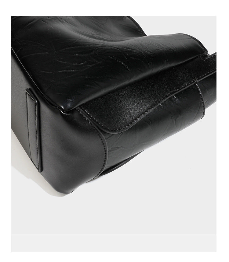 Black glossy crinkled leather-look convertible shoulder tote bag with gold gourd-shaped emblem hardware and detachable