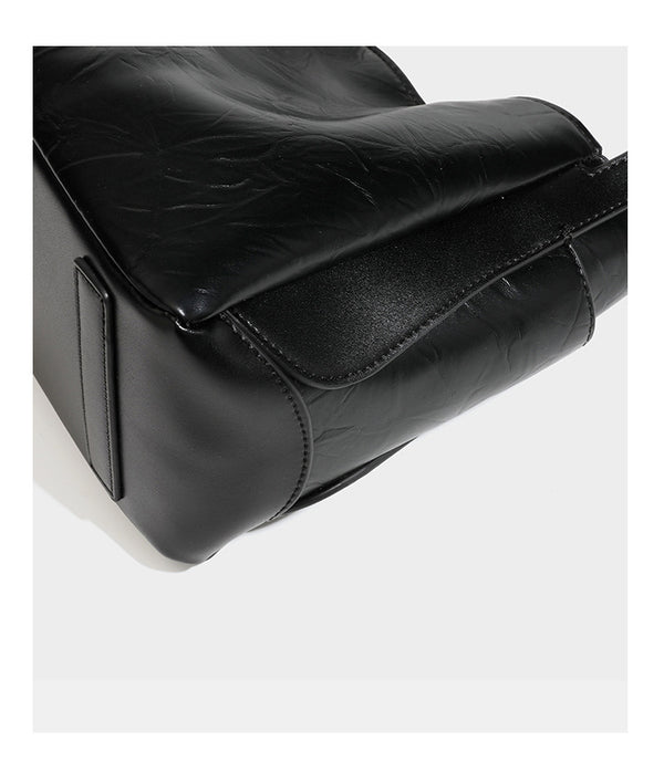 Black glossy crinkled leather-look convertible shoulder tote bag with gold gourd-shaped emblem hardware and detachable