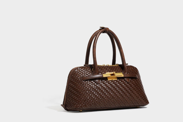 Structured woven-embossed leather-look satchel with dual rolled top handles, gold-tone turn-lock closure, and detachable