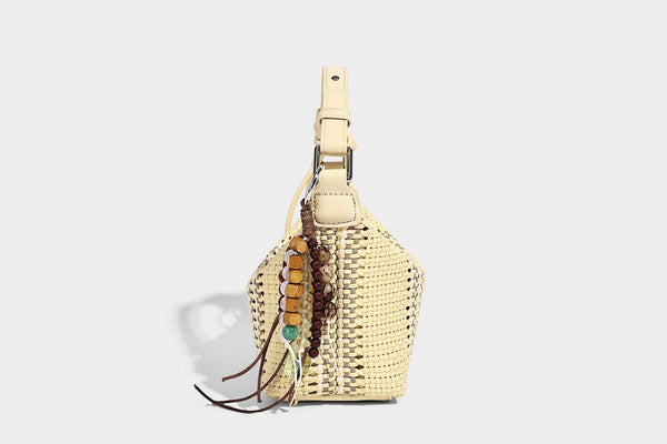 Small woven crescent shoulder bag with leather-look trim, zip closure, silver-tone ring hardware, and beaded tassel charm