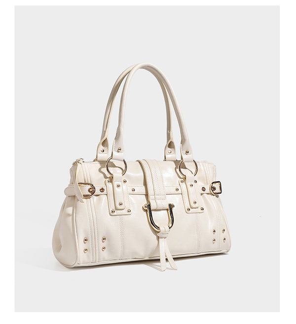 Dark brown glossy leather-look structured satchel tote with gold-tone studs, buckle straps, dual top handles, and detachable