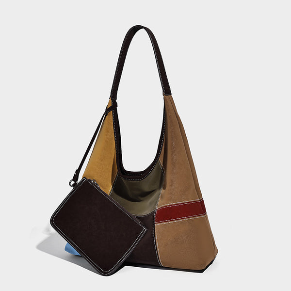 Multicolor patchwork hobo shoulder bag with brown tan olive mustard red and blue suede-look panels, contrast white stitching