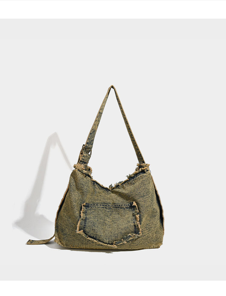 Large distressed denim hobo shoulder bag with mixed-metal rivet detailing and tan leather-look corner trim, detail view 7