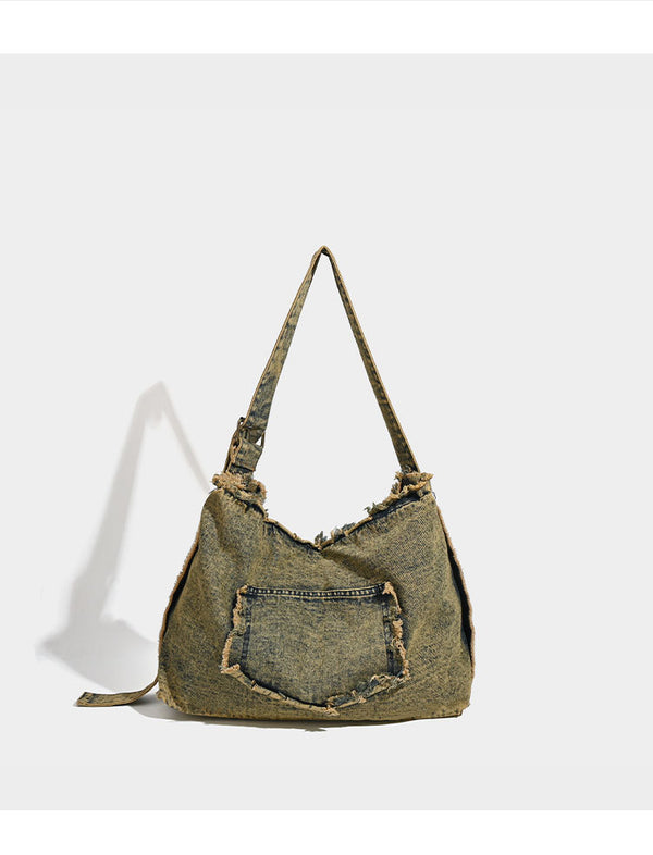 Large distressed denim hobo shoulder bag with mixed-metal rivet detailing and tan leather-look corner trim, detail view 7