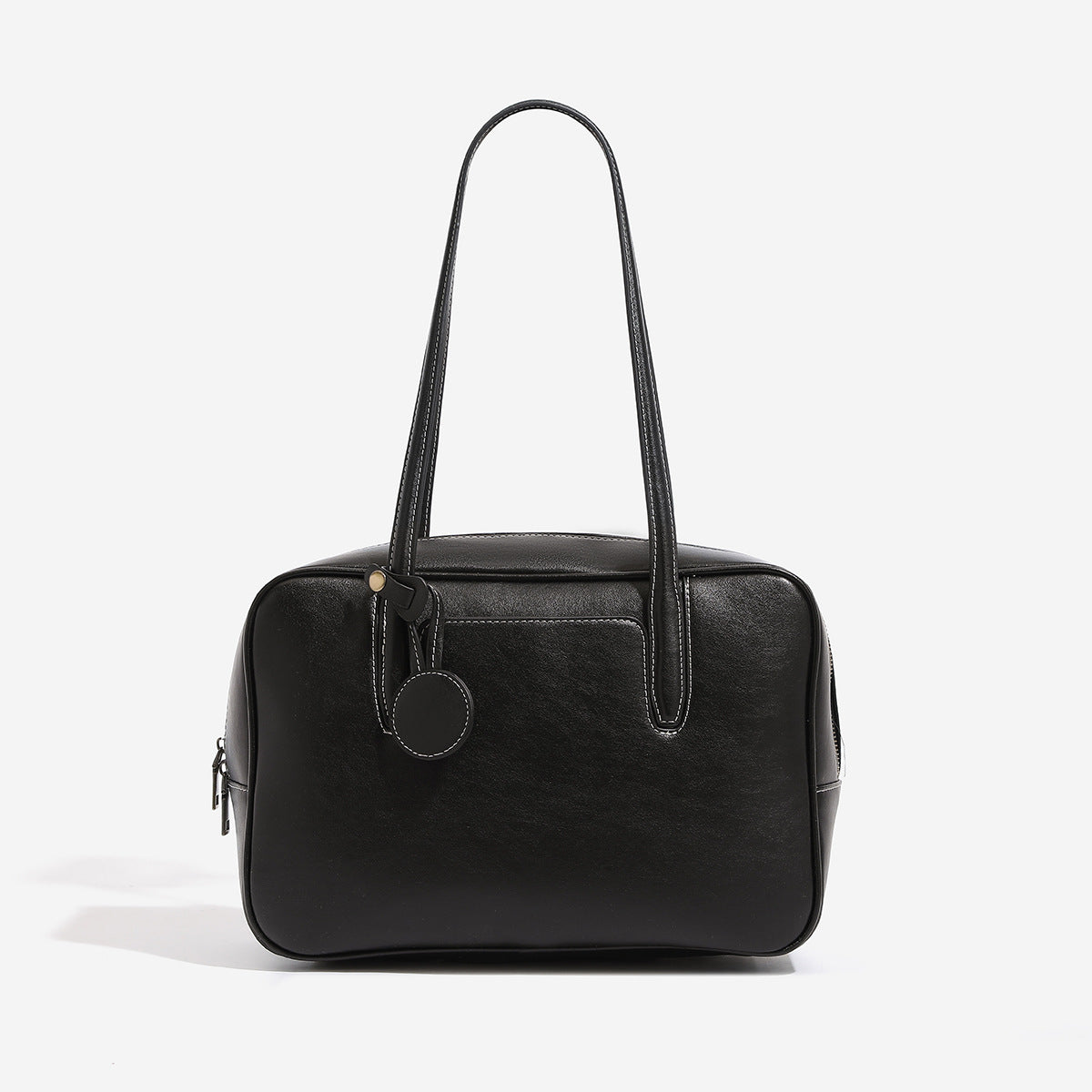 Structured boxy bowling-style tote bag in deep brown leather-look finish with dual top handles, front slip pocket, round