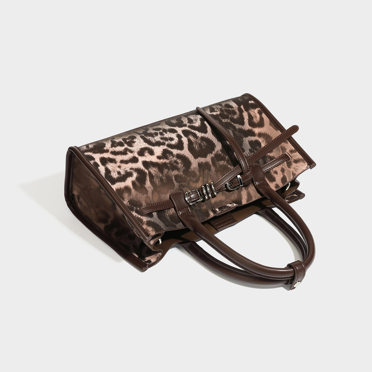 Structured leopard-print tote bag with glossy satin-like finish, dual rounded top handles, silver buckle-and-ring front