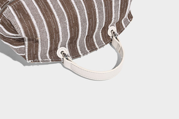 Small structured striped fabric backpack handbag with cream leather-look trim, top handle, and silver-tone hardware, detail