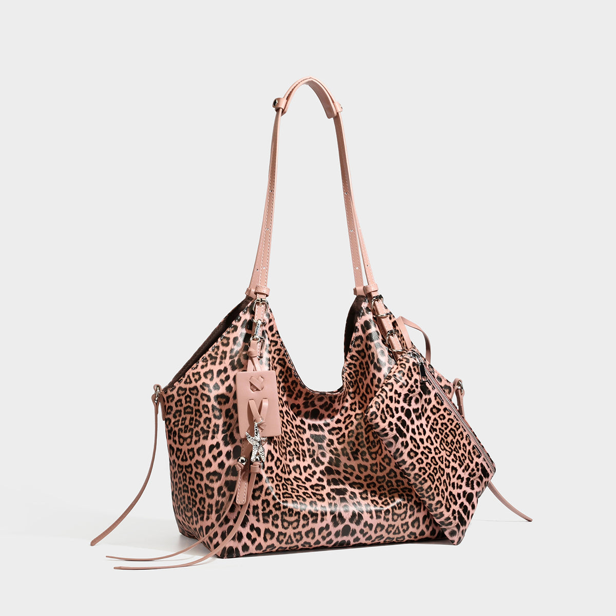 Large leopard print shoulder tote bag with glossy finish, long double straps, front zip pocket, silver-tone hardware, and