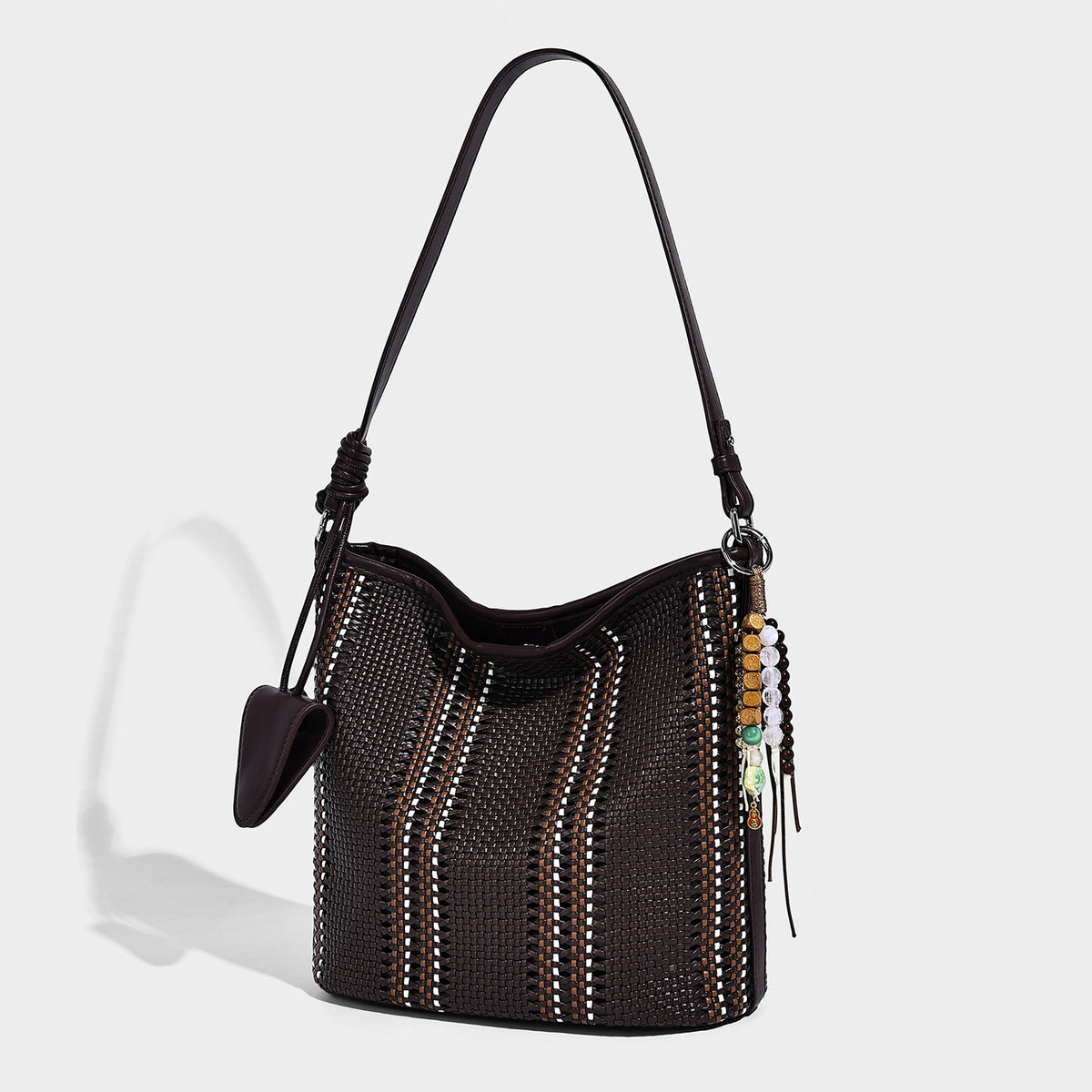 Woven bucket shoulder bag with leather-look trim, silver-tone hardware, and beaded tassel charm, detail view 4