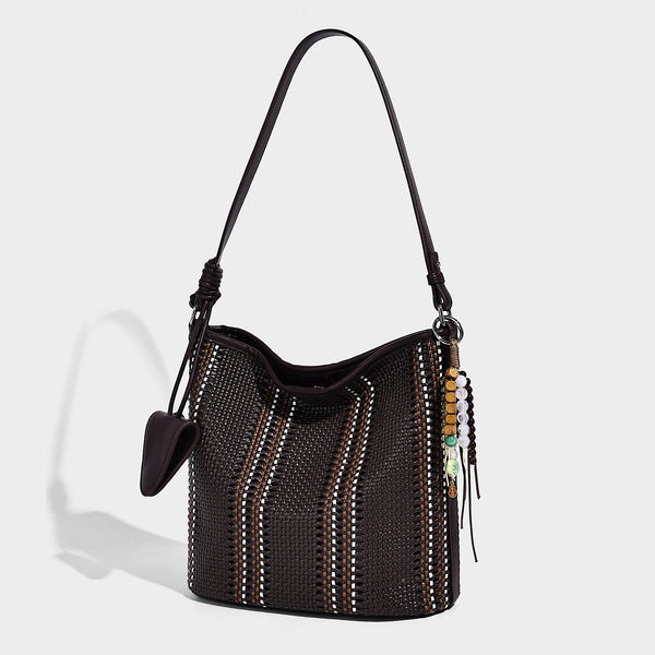Woven bucket shoulder bag with leather-look trim, silver-tone hardware, and beaded tassel charm, detail view 4
