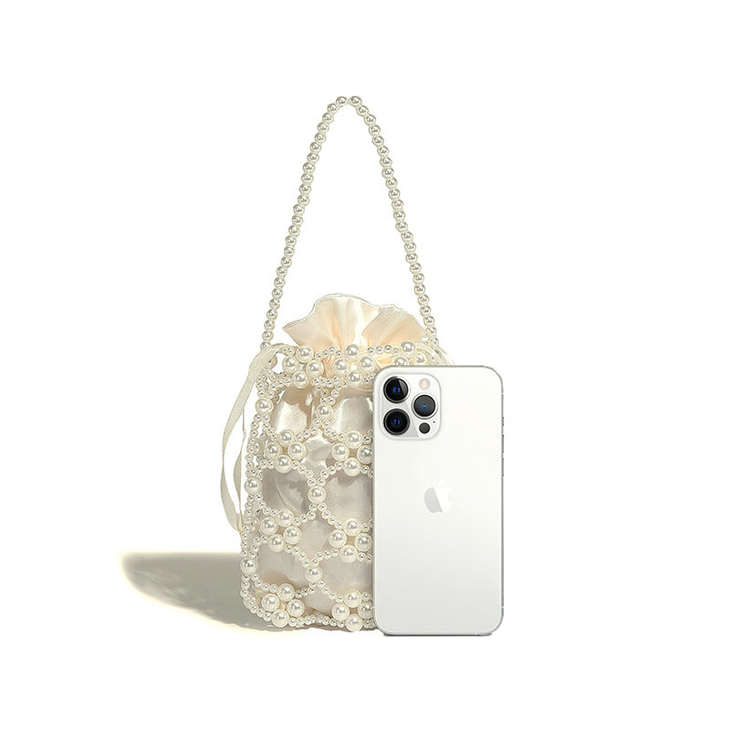 Small pearl-beaded lattice drawstring bucket bag with beaded shoulder strap and ribbon closure, detail view 30