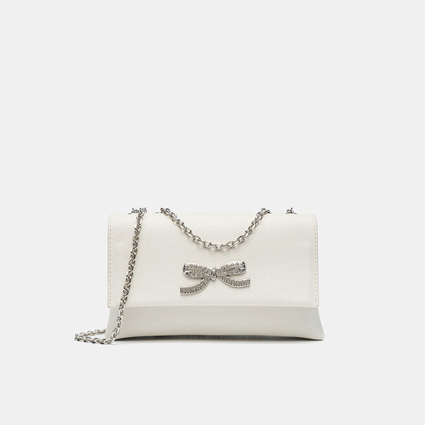 Structured rectangular flap crossbody bag with rhinestone bow and silver chain strap in pebbled finish, detail view 7