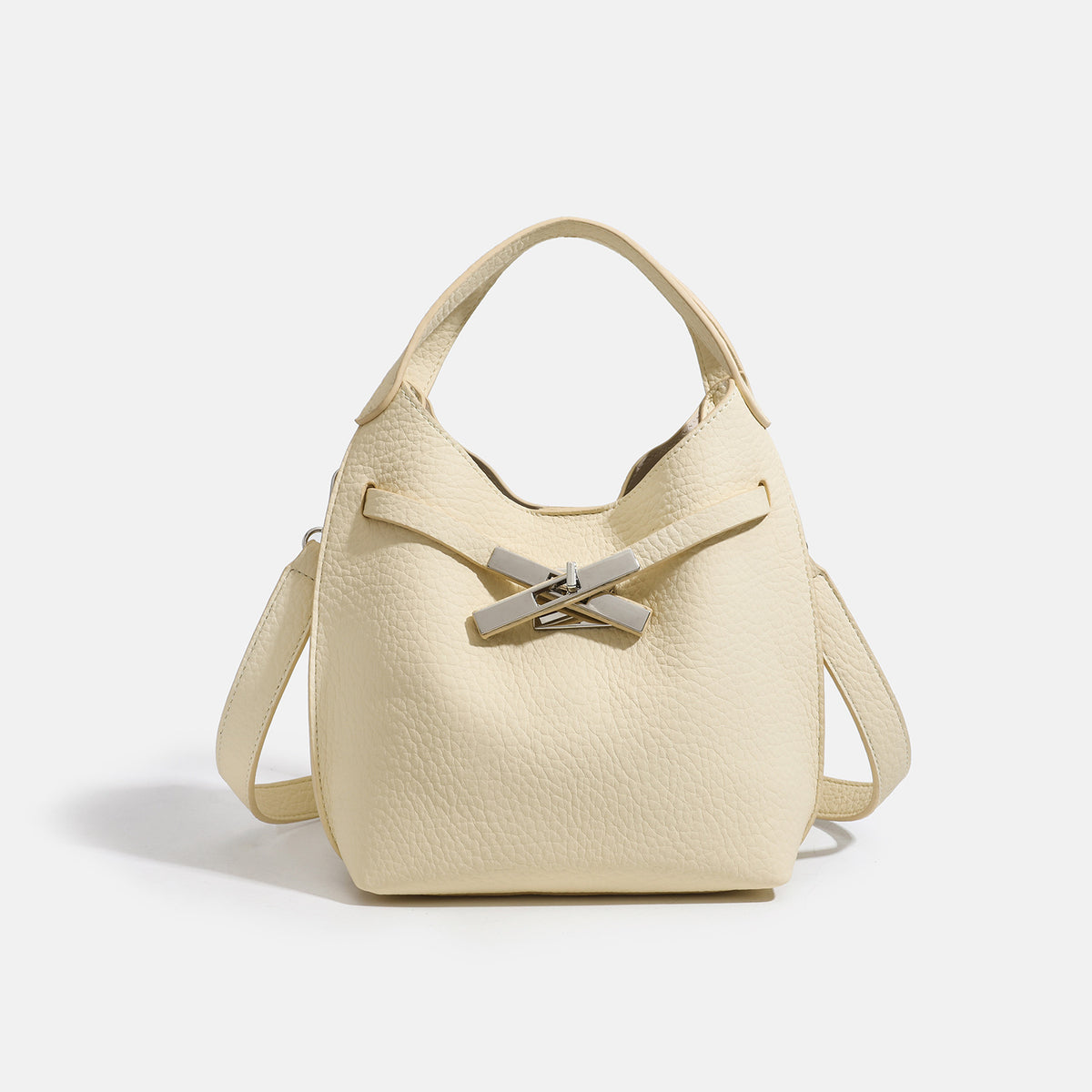 Compact pebbled leather-look shoulder bag with crossed silver-toned metal front closure, short top handle, and long, detail