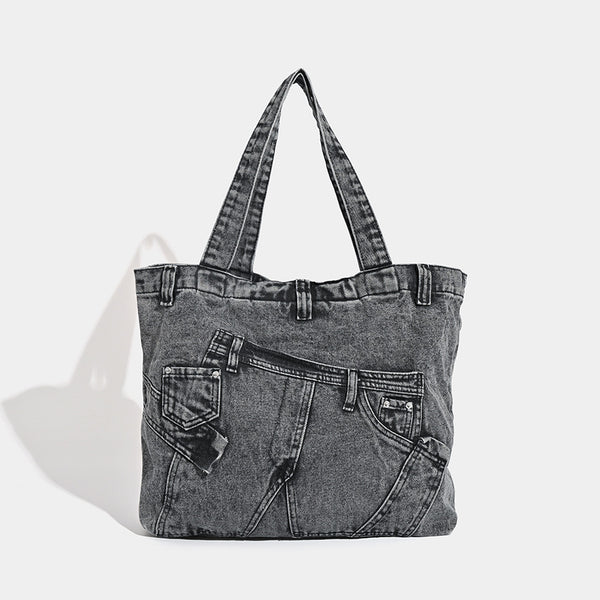 Large washed denim tote bag with jeans-style patch pocket and riveted seam detailing, double shoulder straps, open top