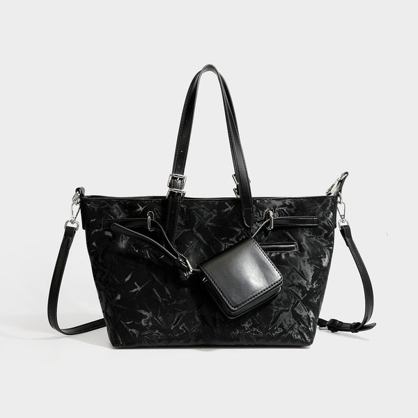 Glossy crinkled metallic-finish tote bag in brown with smooth leather-look top handles, silver-tone hardware, and attached