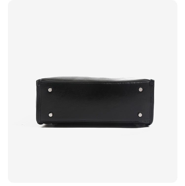 Structured glossy leather-look flap backpack handbag with dual buckle closures, top handle, and silver-tone hardware, detail