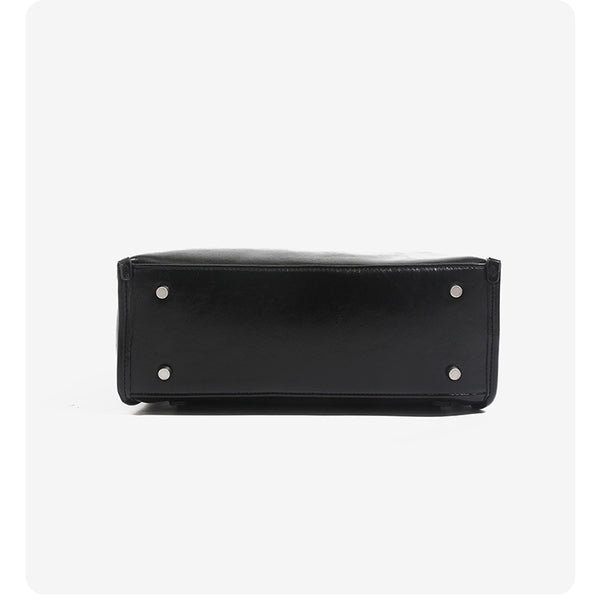 Structured glossy leather-look flap backpack handbag with dual buckle closures, top handle, and silver-tone hardware, detail