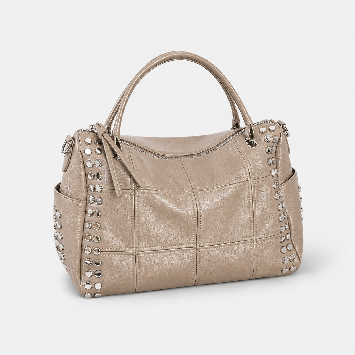 Black leather-look satchel bag with gunmetal rivet trim, grid-stitched paneling, dual rolled top handles, and curved zip