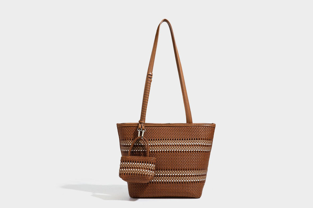 Large structured woven tote bag with striped basket-weave finish, long shoulder straps, and detachable mini pouch charm