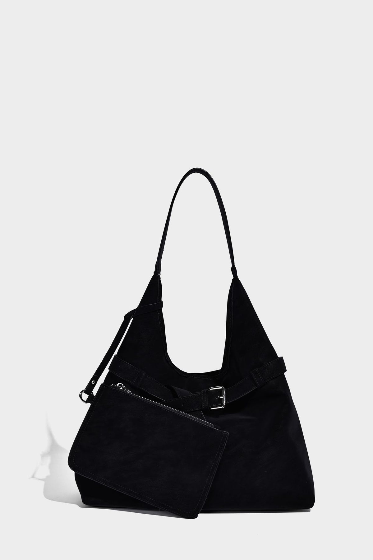 Slouchy oversized shoulder tote bag with matte textured finish, wrap-around buckle strap, and detachable front zip pouch
