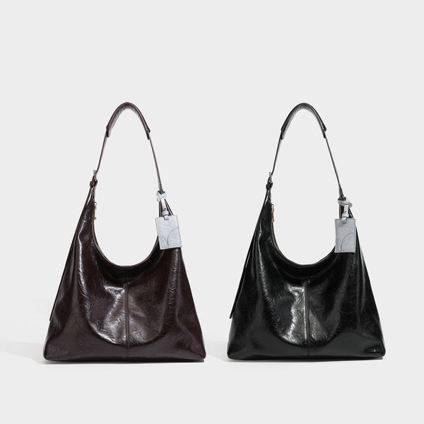 Große dunkelbraune, glänzende Hobo-Schultertasche mit Crinkle-Optik, Reißverschluss, goldfarbenen Metalldetails, verstellbarem Riemen und Hellblau