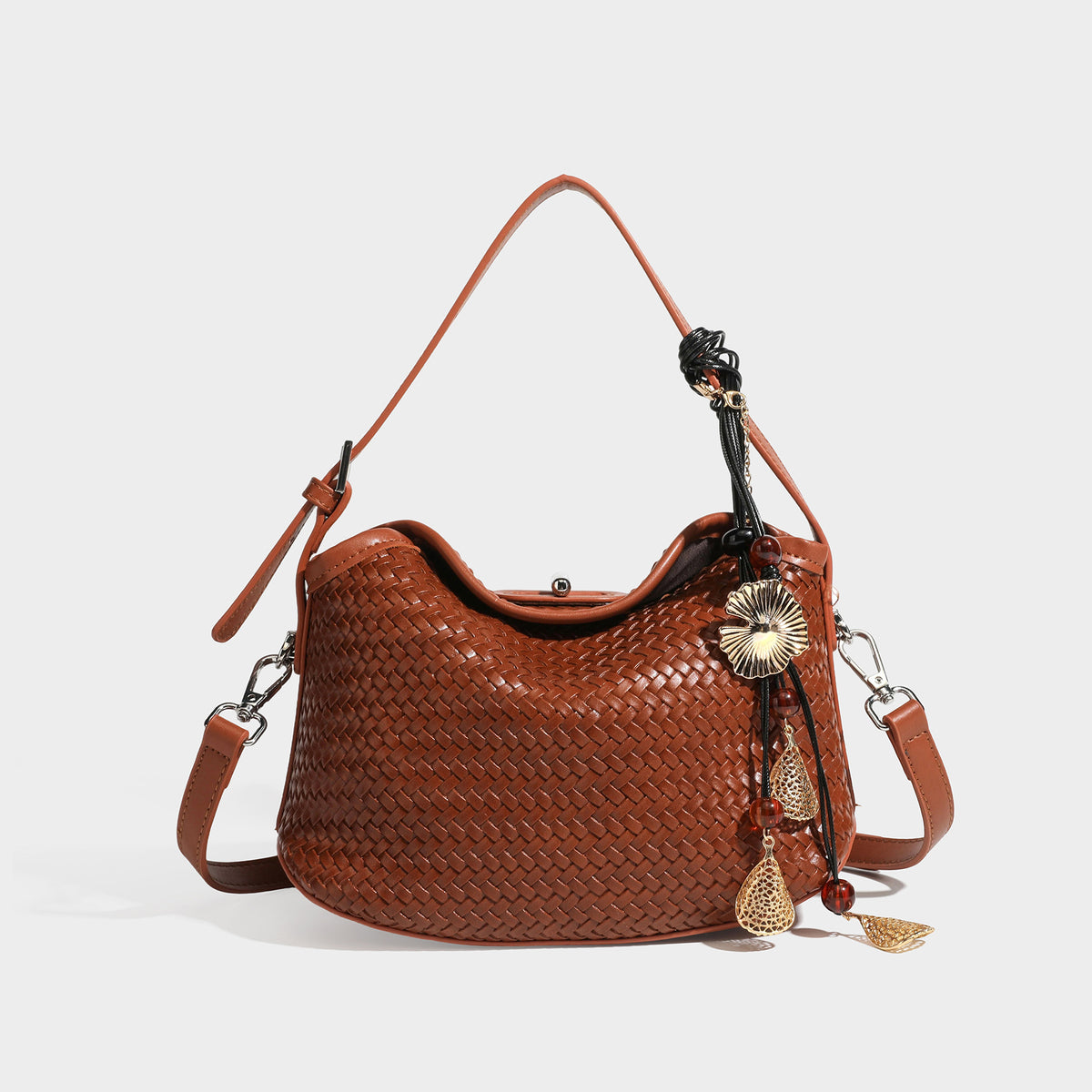 Small woven-look leather-look flap shoulder hobo bag in burgundy with silver-tone hardware and decorative tassel charm