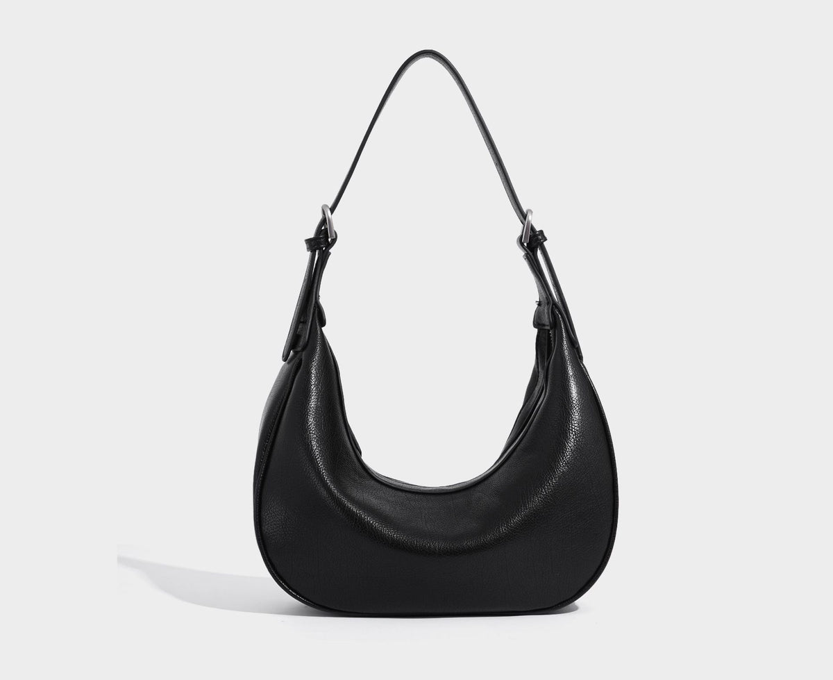 Crescent half-moon shoulder bag in pebbled leather-look finish with adjustable strap and silver-tone hardware, detail view 17