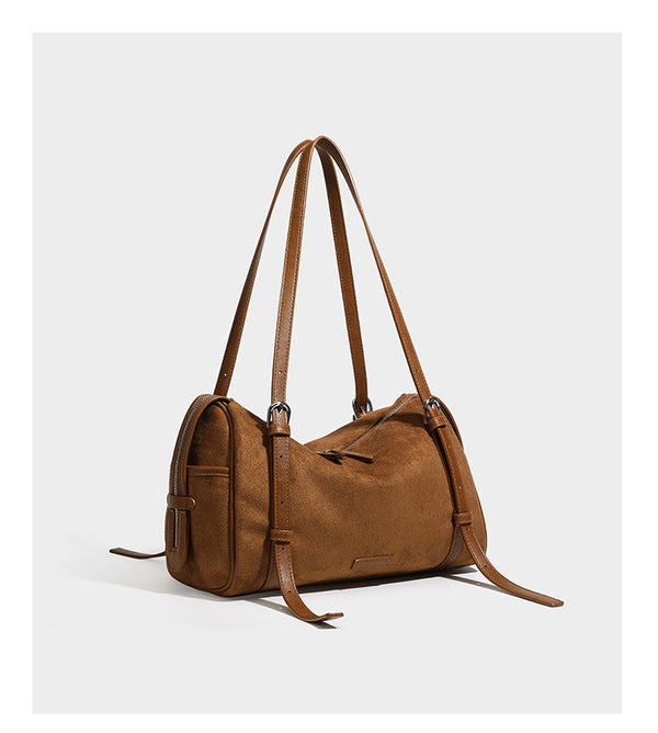 Large brown suede-finish barrel shoulder bag with dark leather-look trim, silver-tone zippers, dual top handles, and long