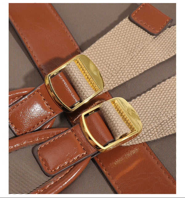 Soft rectangular nylon convertible backpack handbag with leather-look trim, snap-flap closure, top carry handles, padded