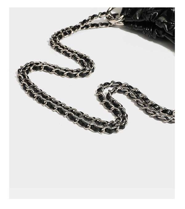 Glossy diamond-quilted drawstring bucket bag with silver chain shoulder strap and medallion charm, detail view 20