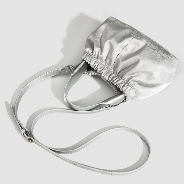 Small ruched satin-finish cloud bag with elasticized drawstring top, short top handle, and chunky silver-tone chain strap