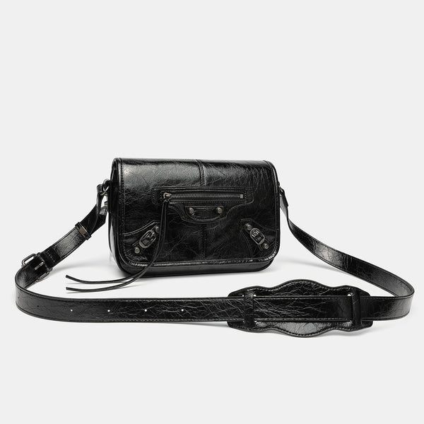 Small structured rectangular crossbody bag with crinkle leather-look finish, front zip pocket, gunmetal stud hardware, and