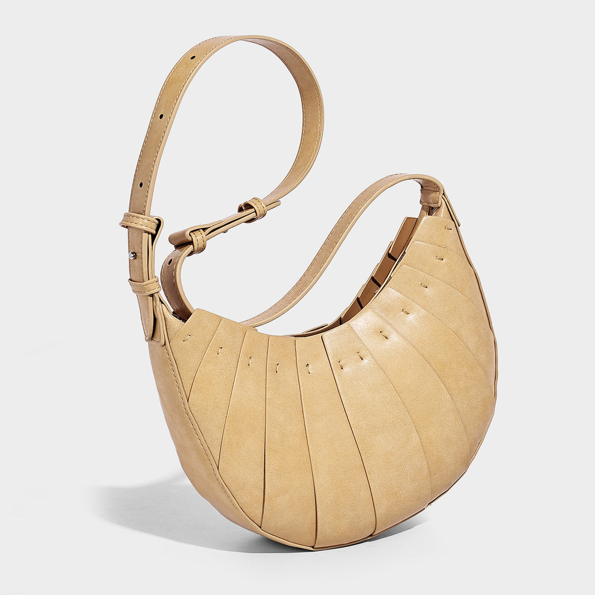 Crescent half-moon shoulder bag with vertical panel seaming, matte-satin leather-look finish, and adjustable gold-tone