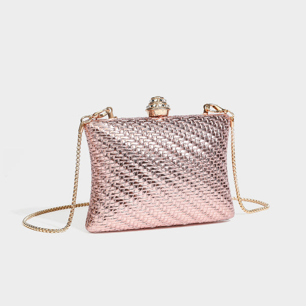 Small structured rectangular metallic woven-texture clutch bag with jeweled knob clasp and gold-tone chain strap, detail view