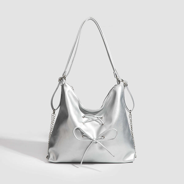 Glossy leather-look hobo shoulder bag with front bow lacing detail and silver-tone chain strap, detail view 8
