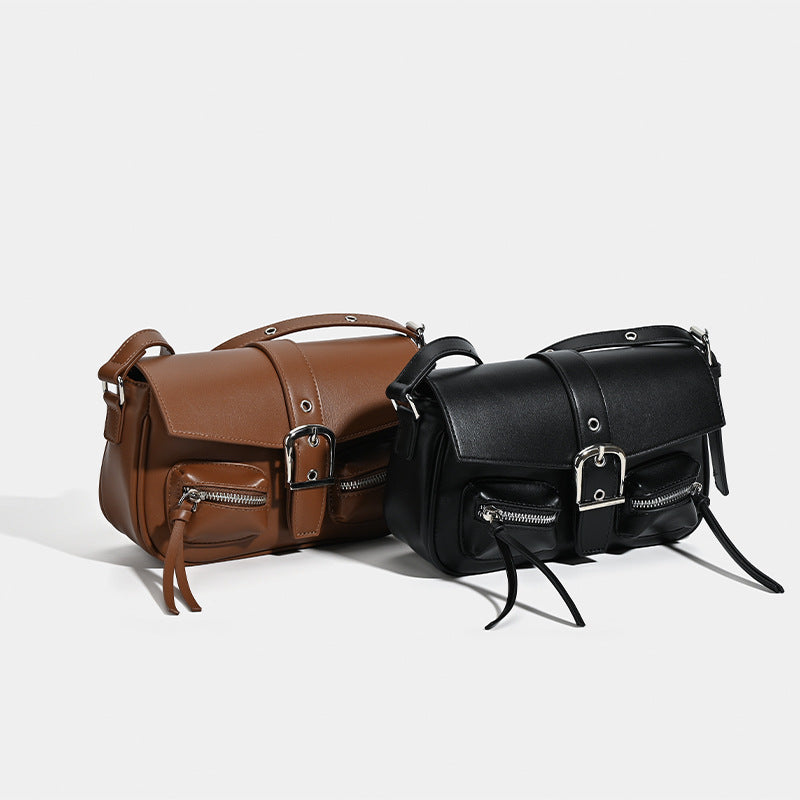 Structured flap crossbody bag with front buckle strap and dual zip pockets in smooth leather-look finish with silver-tone