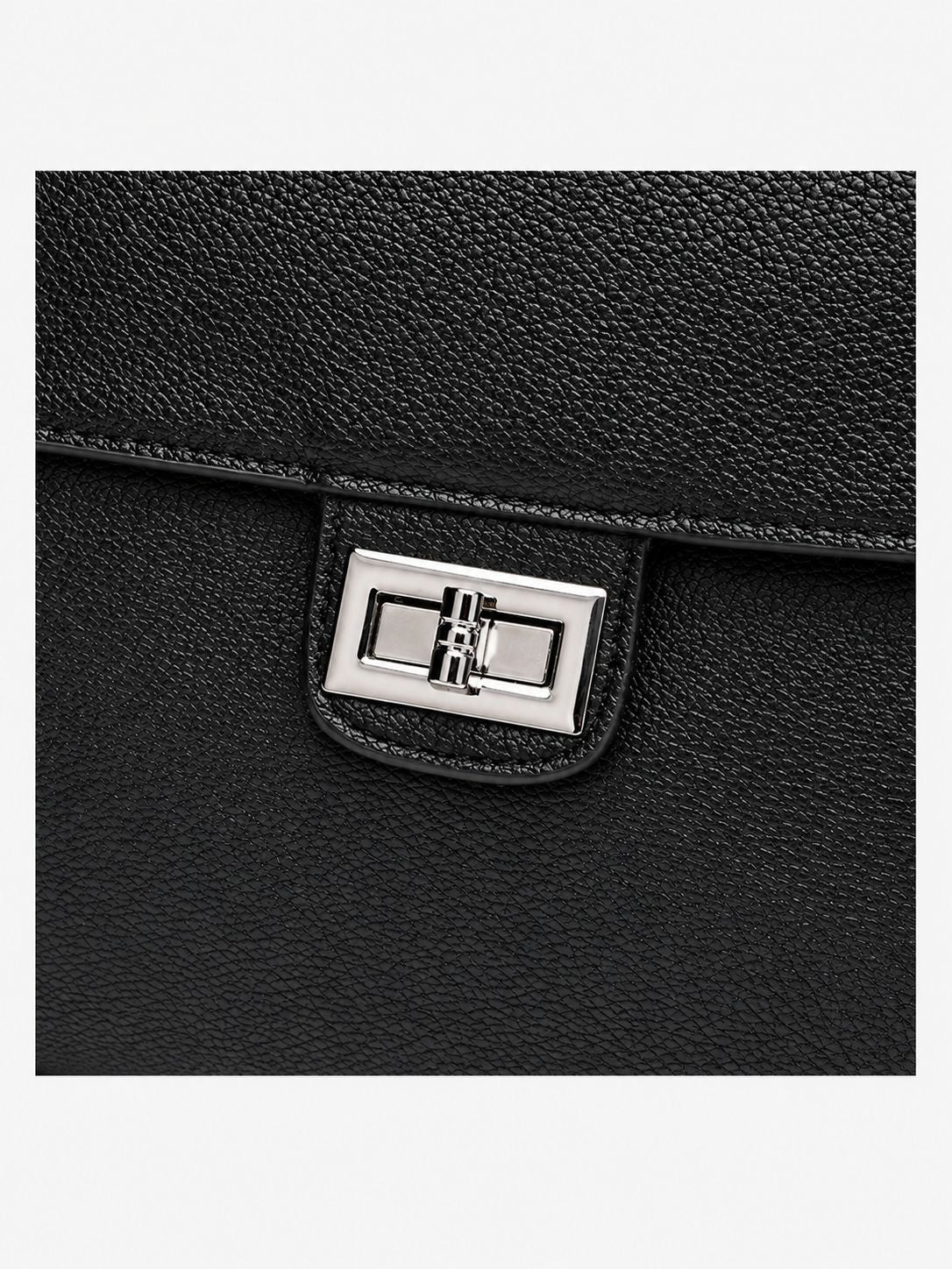 Structured black flap shoulder bag with pebbled texture, silver-tone turn-lock closure, and adjustable single shoulder strap