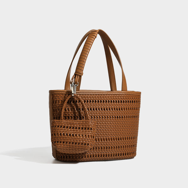 Structured open-weave tote bag with smooth leather-look trim, double top handles, detachable crossbody strap, and mini zip