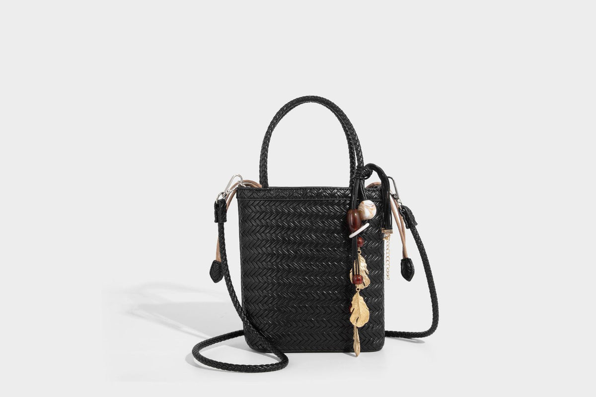 Small structured woven-texture tote bag with braided top handles and drawstring inner pouch, detail view 22