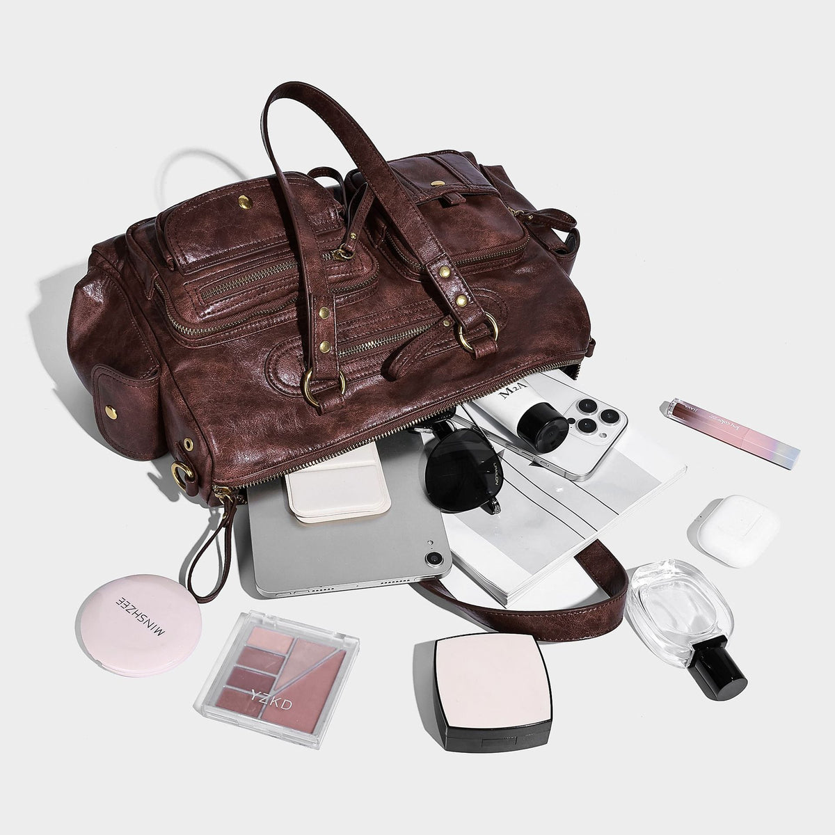 Distressed leather-look vintage satchel shoulder bag with multiple front zip pockets, dual top handles, and brass-tone