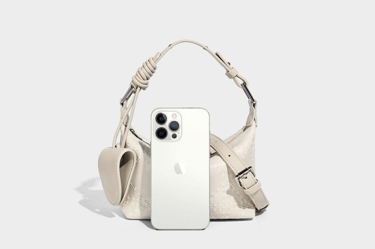 Small embossed half-moon shoulder bag with top zipper, detachable front pouch, and adjustable slim strap, detail view 12