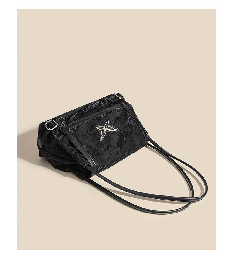 Structured crinkle-finish flap shoulder bag with butterfly metal appliqué and dark brown contrast trim, detail view 11