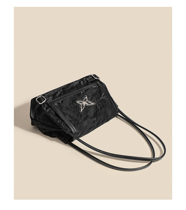Structured crinkle-finish flap shoulder bag with butterfly metal appliqué and dark brown contrast trim, detail view 11