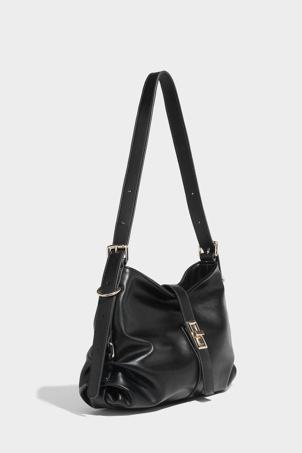 Soft slouchy hobo shoulder bag with smooth leather-look finish, gold-tone buckle and tab hardware, and long adjustable strap