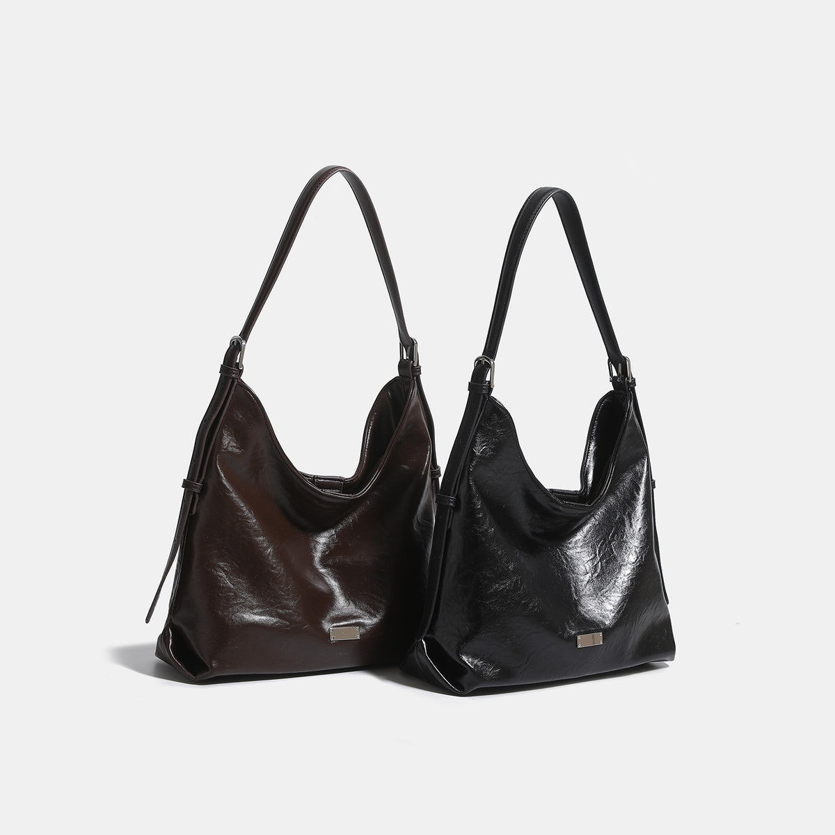 Slouchy hobo shoulder bag with glossy wrinkled leather-look finish, adjustable strap, and snap closure, detail view 2
