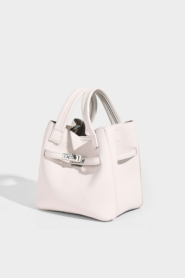 Small structured pebbled bucket tote bag with dual top handles, silver turn-lock front pocket, and detachable shoulder strap